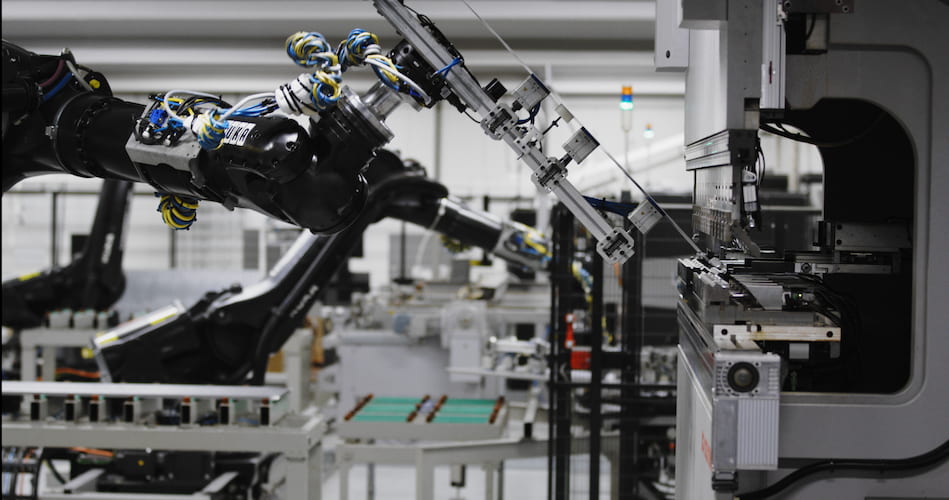 Robot arm at production that makes electric power distribution units and boxes for industrial use