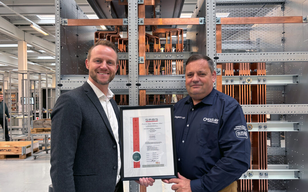 Morten and Ludi holding the SABS certification, Logstrup Assembly